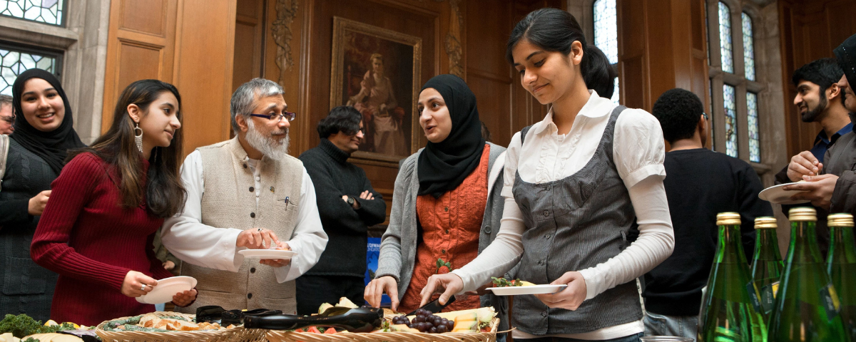 People getting food from a buffet.