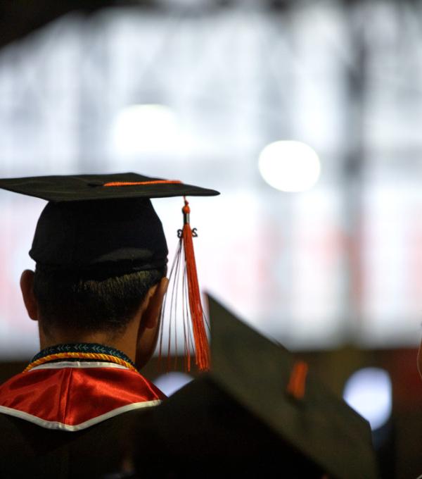 Graduates standing inside of Barton Hall