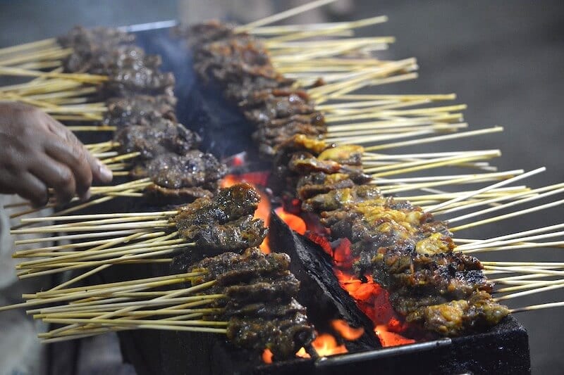 Satay cooking over flame