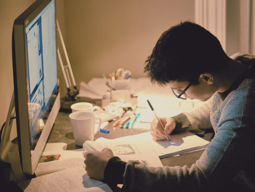 creative student working at a desk in front of a computer | screen fatigue