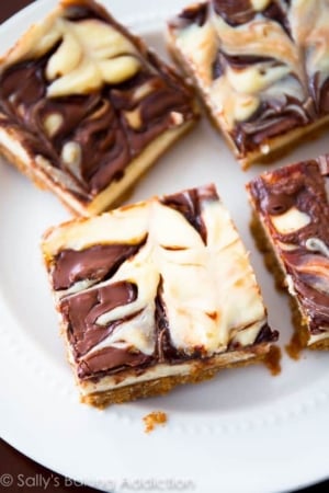 Nutella swirl cheesecake bars on a white plate