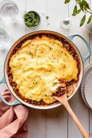 vegetable shepherd's pie with mashed potatoes on top in blue pan.