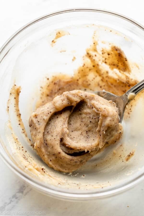 solidified brown butter in glass bowl with spoon.