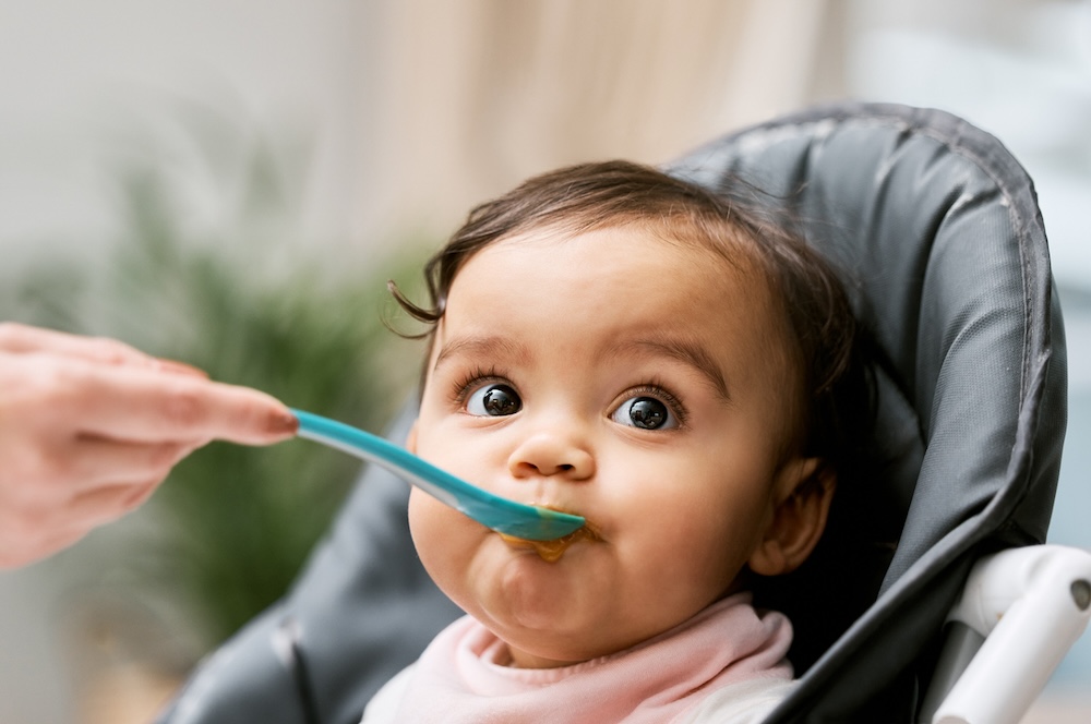 Infant being fed baby food from a spoon