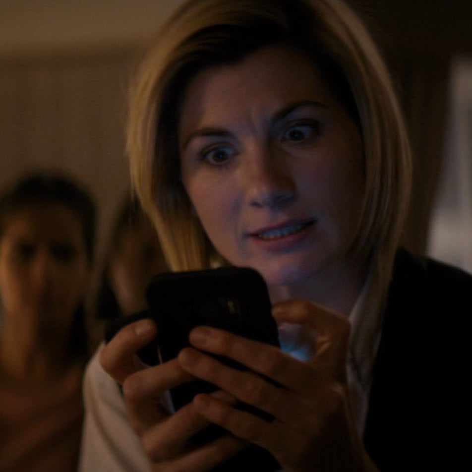 The Doctor holding Ryan's phone.