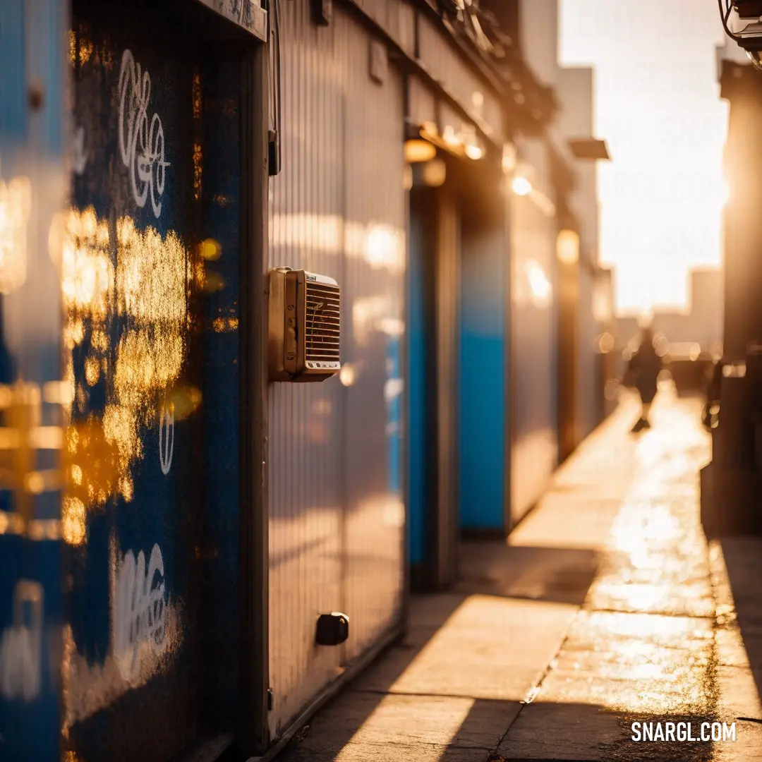 A row of open storage units on a city street at sunset, bathed in golden light from the setting sun, casting long shadows over the area.