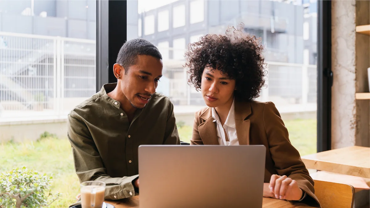 Two marketers evaluating campaign performance in an office.