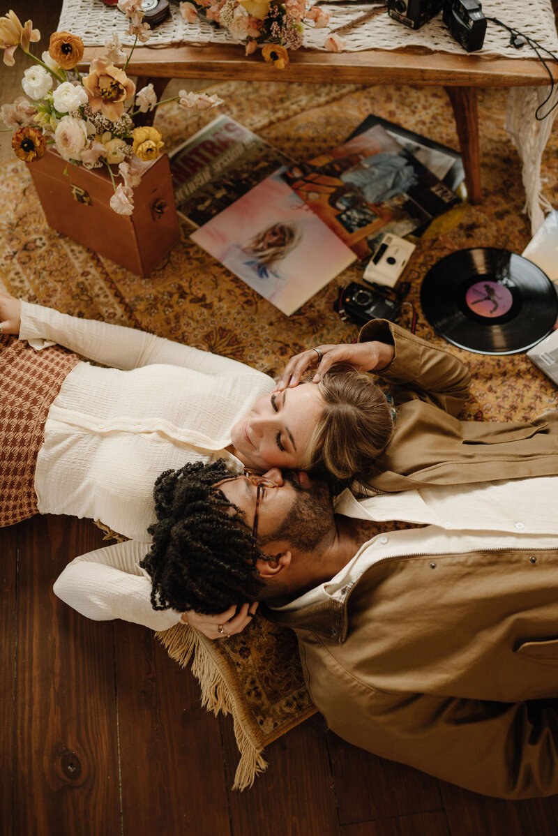 Couple with old records for a photoshoot in their home