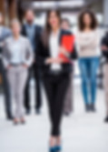 Smiling business woman holding a red file stands in front of smiling business persons. iGaming, sports betting