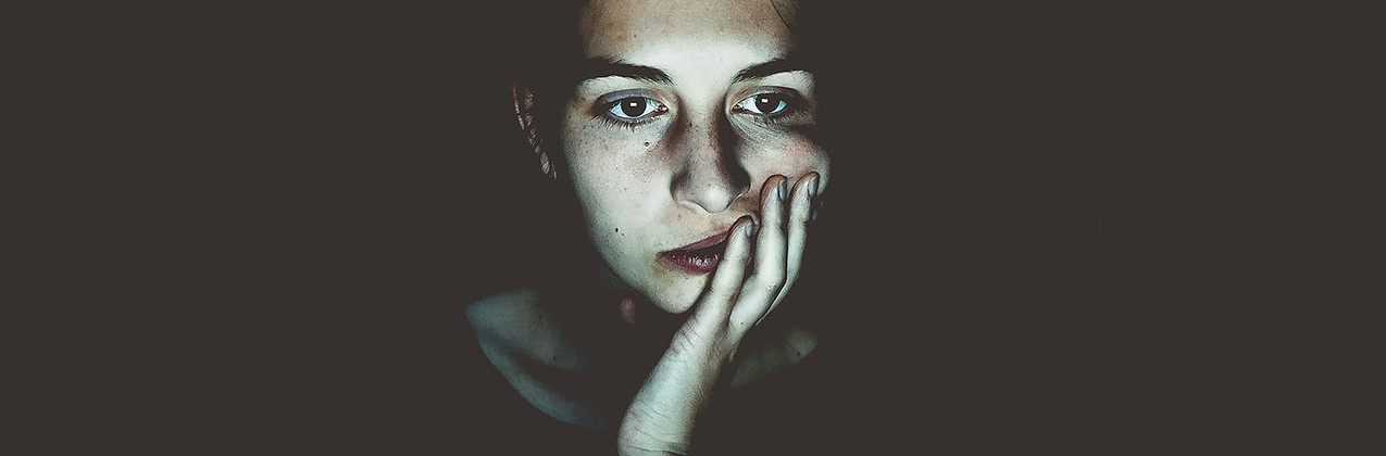 Woman sitting in the dark