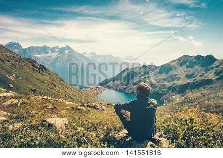 Traveler Man relaxing meditation with serene view mountains and lake landscape Travel Lifestyle hiking concept summer vacations outdoor