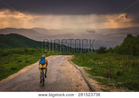 Cycling In Sunset. Lifestyle Concept. Man Cycling In Sunset In Mountain. Healthy Lifestyle. People L