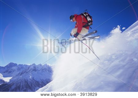 Man Skiing Off Mountain