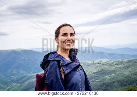 Beautiful Woman Smiling In Nature. Happy People Lifestyle. Woman Smiling In Nature While Hiking In M