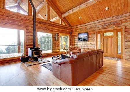 Luxury Log Cabin Living Room With Leather Sofa.