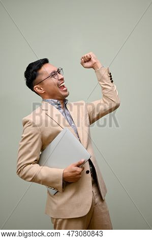 Cheerful And Excited Asian Businessman Celebrating His Success, Showing Clenched Fist