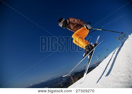 Skier girl jumping over blue sky