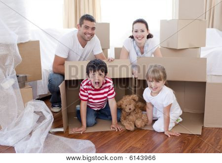 Family Moving House With Boxes Around