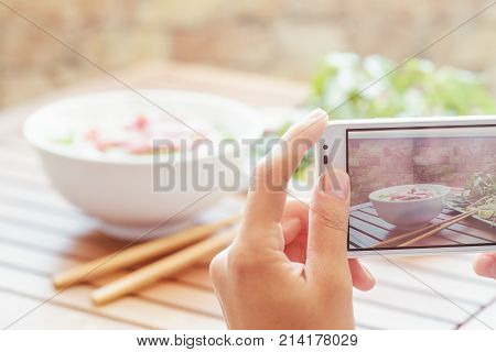 Taking A Picture Of Pho Bo In Street Cafe In Vietnam