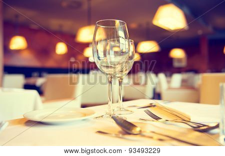 Served dinner table in a restaurant. Restaurant interior. Cozy restaurant table setting. Defocused background