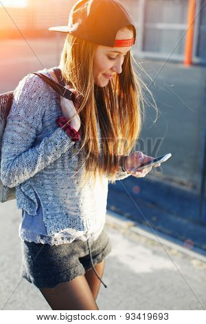 Portrait of a young stylish girl that wrote the message on the phone