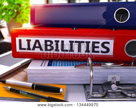 Red Office Folder with Inscription Liabilities on Office Desktop with Office Supplies and Modern Laptop. Liabilities Business Concept on Blurred Background. Liabilities - Toned Image. 3D.