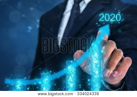 2020 Concept,business Man Point Hand On The Top Of Arrow Graph With High Rate Of Growth In Year 2020