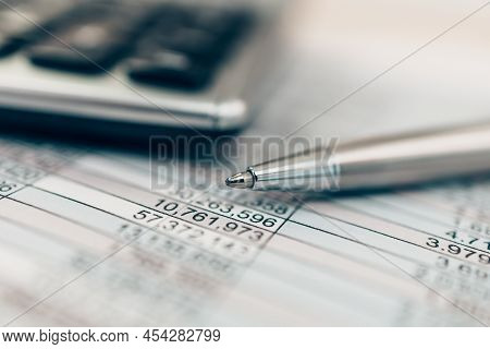 Pen And Calculator On Desk Office. Object For Calculator To Calculate Balance, Projit, Currency And 