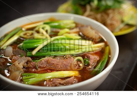 
 Save
Download Preview
Traditional vietnamese noodle soup pho in bowl garnished with basil mint lime on concrete background. Vietnamese beef soup pho bo. Close-up. Vietnamese dinner. Pho bo meal