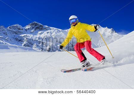 Skiing, skier, winter sport - woman skiing downhill