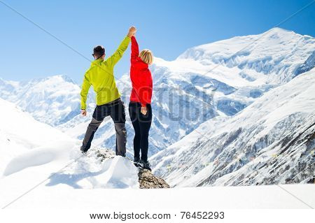 Couple Hiking Man And Woman Success In Winter Mountains