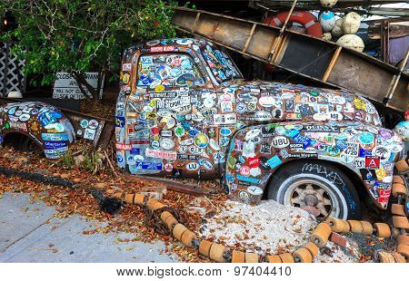 Old Car Covered With A Variety Of Stickers