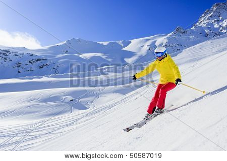 Skiing, skier, winter sport - woman skiing downhill