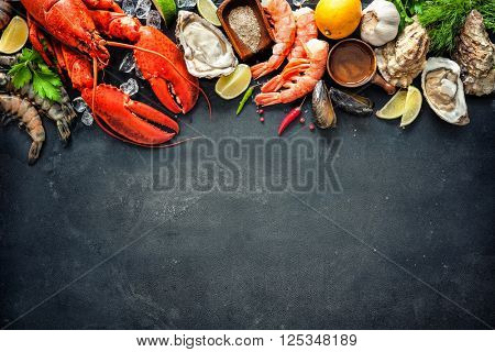 Shellfish plate of crustacean seafood with fresh lobster, mussels, oysters as an ocean gourmet dinner background