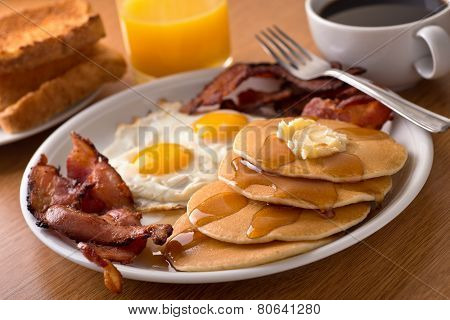 Breakfast With Bacon, Eggs, Pancakes, And Toast