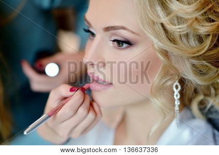 Wedding Makeup Artist Making A Make Up For Bride. Beautiful Sexy Model Girl Indoors. Beauty Woman Wi