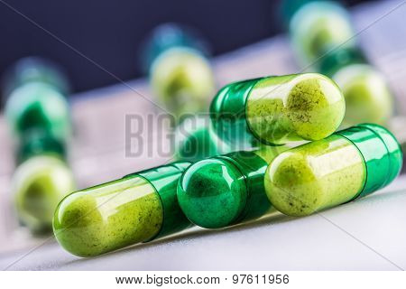 Pills. Tablets. Capsule. Heap of pills. Medical background. Close-up of pile of yellow green tablets