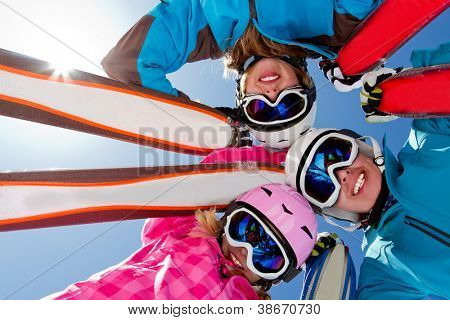 Skiing, winter fun - skiers enjoying ski holidays