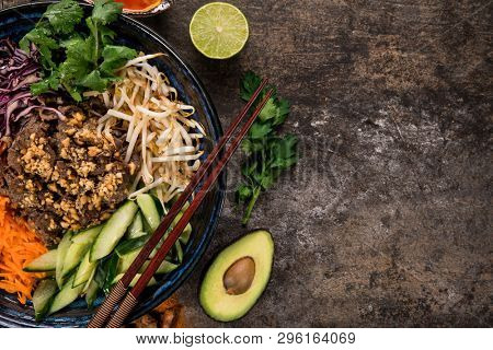 Bun bo nam bo asian food background with various ingredients on rustic stone background , top view. Vietnam or Thai cuisine.