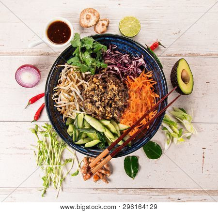 Bun bo nam bo asian food background with various ingredients on rustic wooden background , top view. Vietnam or Thai cuisine.