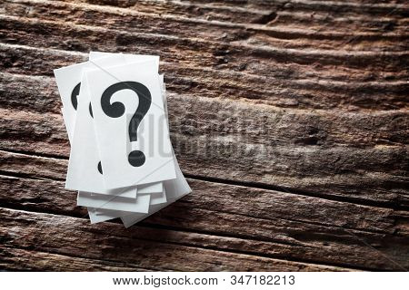 Question mark heap on wood background concept for confusion, question or solution