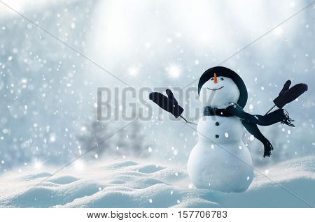 Merry christmas and happy new year greeting card with copy-space.Happy snowman standing in winter christmas landscape.Snow background