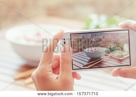 Taking A Picture Of Pho Bo In Street Cafe, Vietnam