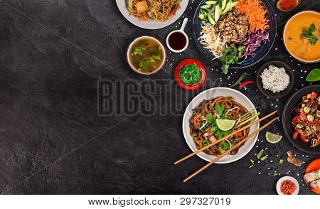 Asian food background with various ingredients on rustic stone background , top view. Vietnam and Thai cuisine.