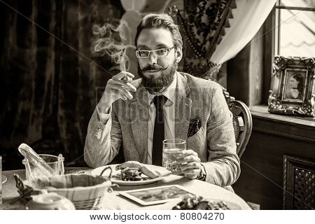 Man With A Beard And Mustache, Smoking A Cigar During Dinner