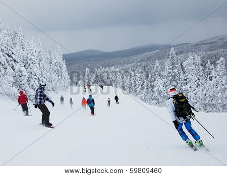 MONT-TREMBLANT, QUEBEC, CANADA -FEBRUARY 9: Skiers and snowboarders are sliding down an easy slope at Mont-Tremblant Ski Resort on February 9, 2014. It is the best ski resort in Eastern North America.