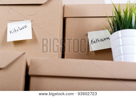 Pile Of Brown Cardboard Boxes With House Or Office Goods.