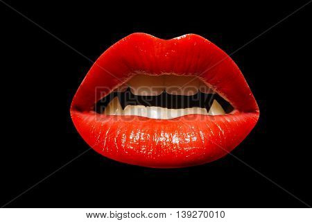 female open mouth with red sexy lips and white teeth and fangs of vampire isolated on black background