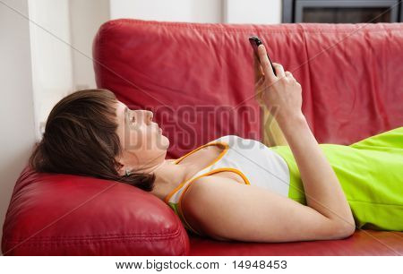 Woman Texting On Sofa