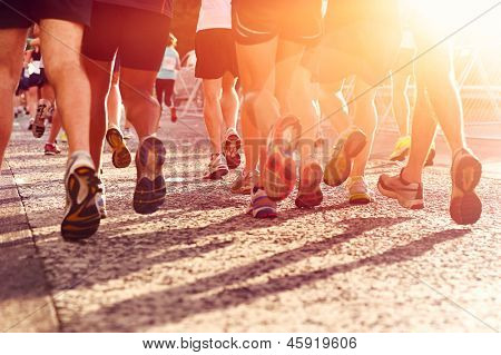 Marathon running race people competing in fitness and healthy active lifestyle feet on road